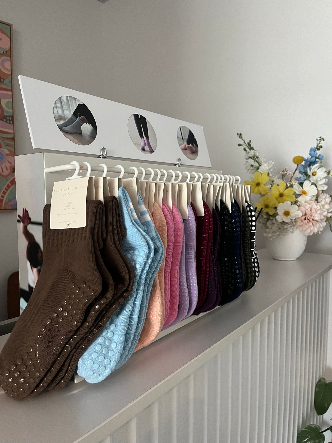 TPD Store Grippy sock display rack with ankle length and crew cut grippy socks. Ideal for studio or store pilates/ yoga equipment sales.