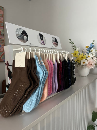 TPD Store Grippy sock display rack with ankle length and crew cut grippy socks. Ideal for studio or store pilates/ yoga equipment sales.