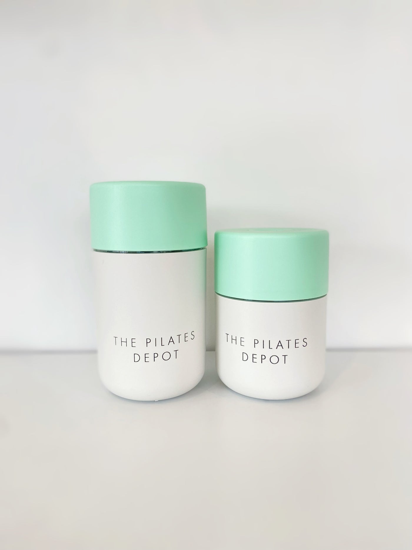 pilates depot frank green coffee cups in two sizes with mint green lids and white bases