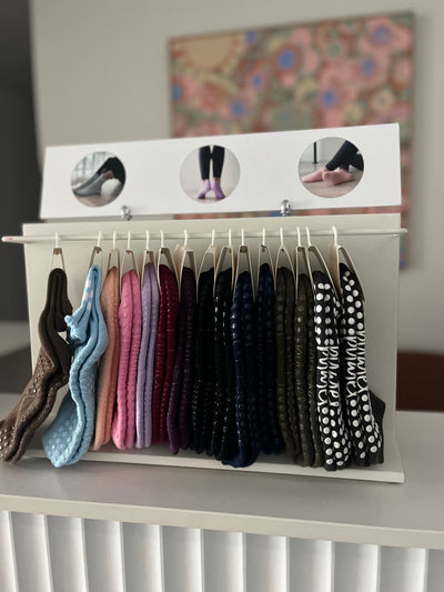 shelf with tpd store grippy sock display rack for wholesale on a shelf with several pairs of grippy socks 