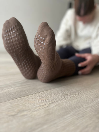 A pair of flexed feet in Mocha Brown TPD Store Grippy socks