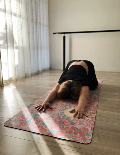 woman in childs pose on you are my sunshine eco friendly yoga mat from tpd store