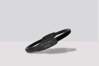 black pilates right with the pilates depot on the side rests lying on a white background