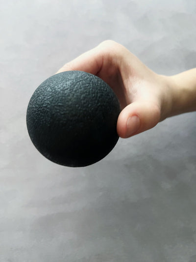 hand holding a black tpd store trigger ball 
