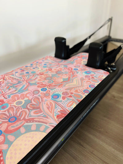 full view of TPD Store you are my sunshine Aurora Art collab print reformer mat. Mat is floral print on a pilates machine