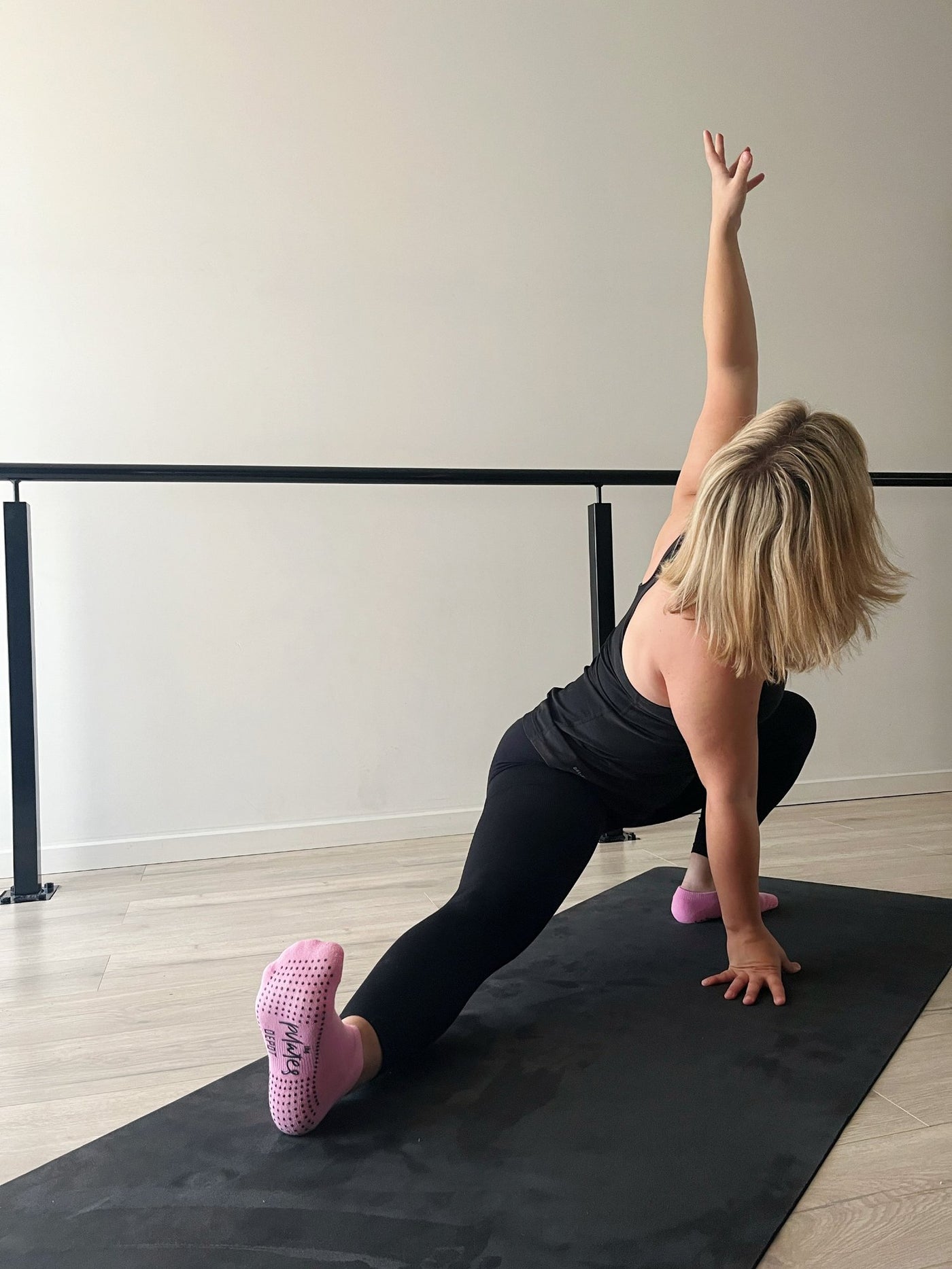 woman in side strech with black tpd store eco friendly yoga mat