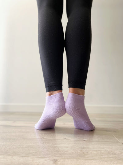 pair of feet in TPD store Grippy socks in French Lavender low rise style