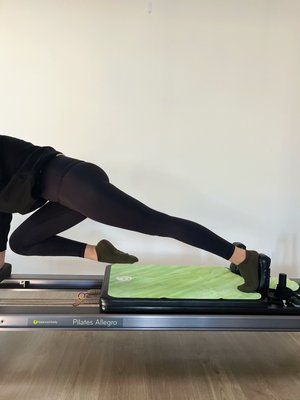 woman on a reformer wearing a pair of tpd store kahki low rise grippy socks
